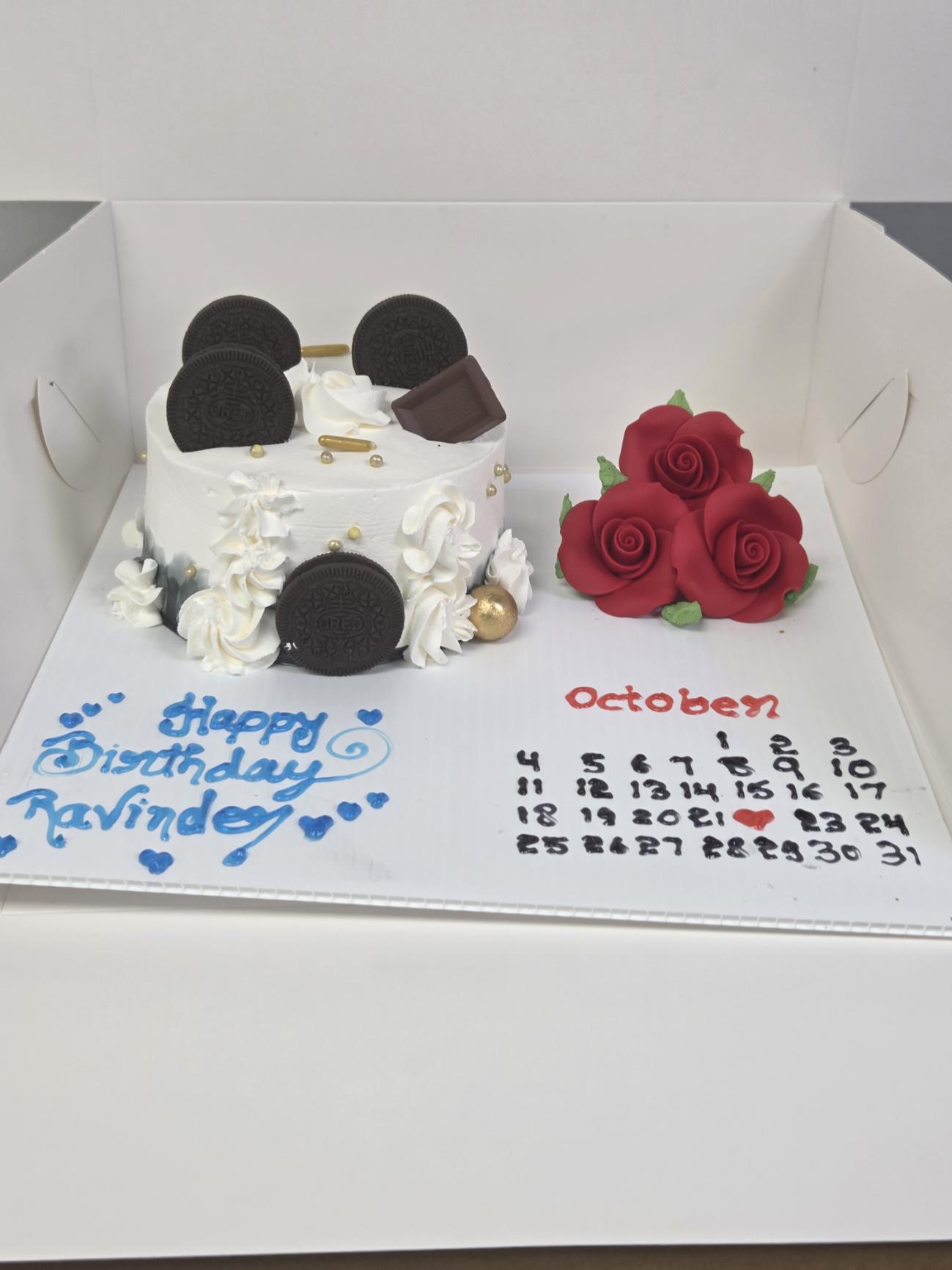 Custom white Oreo birthday cake with red roses and October calendar from Manohar Vegetarian Bakery in Kelowna